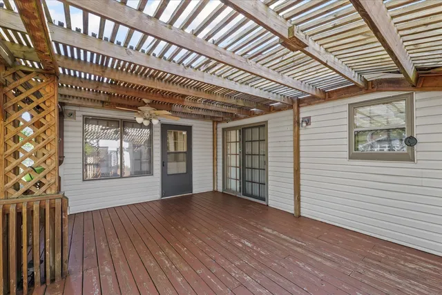 a view of a house with a wooden deck
