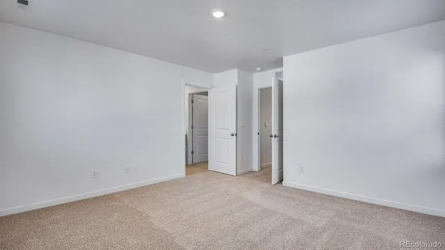 an empty room with windows and closet