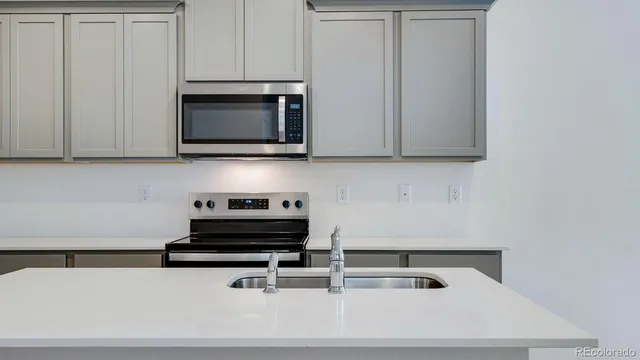 a kitchen with a stove and a microwave