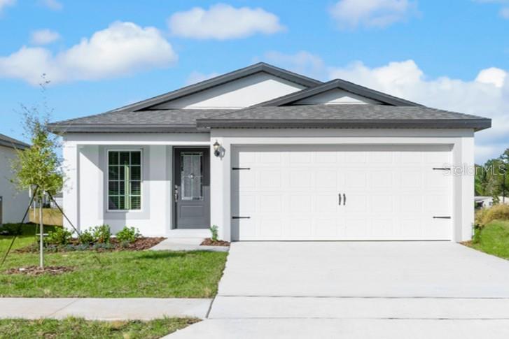 13328 Tula Loop Astatula, FL 34705 - Photo 1 of 18 a front view of a house with a yard