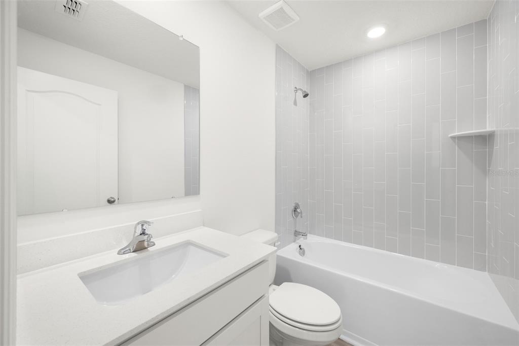 13328 Tula Loop Astatula, FL 34705 - Photo 12 of 18 a bathroom with a sink toilet and bathtub
