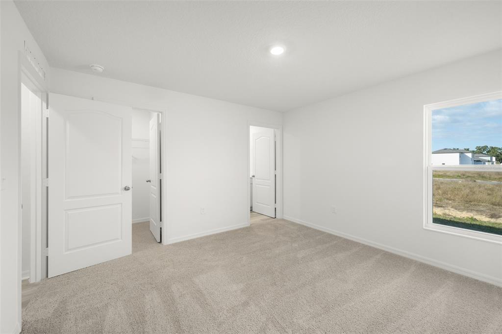 13328 Tula Loop Astatula, FL 34705 - Photo 5 of 18 a view of an empty room with a window