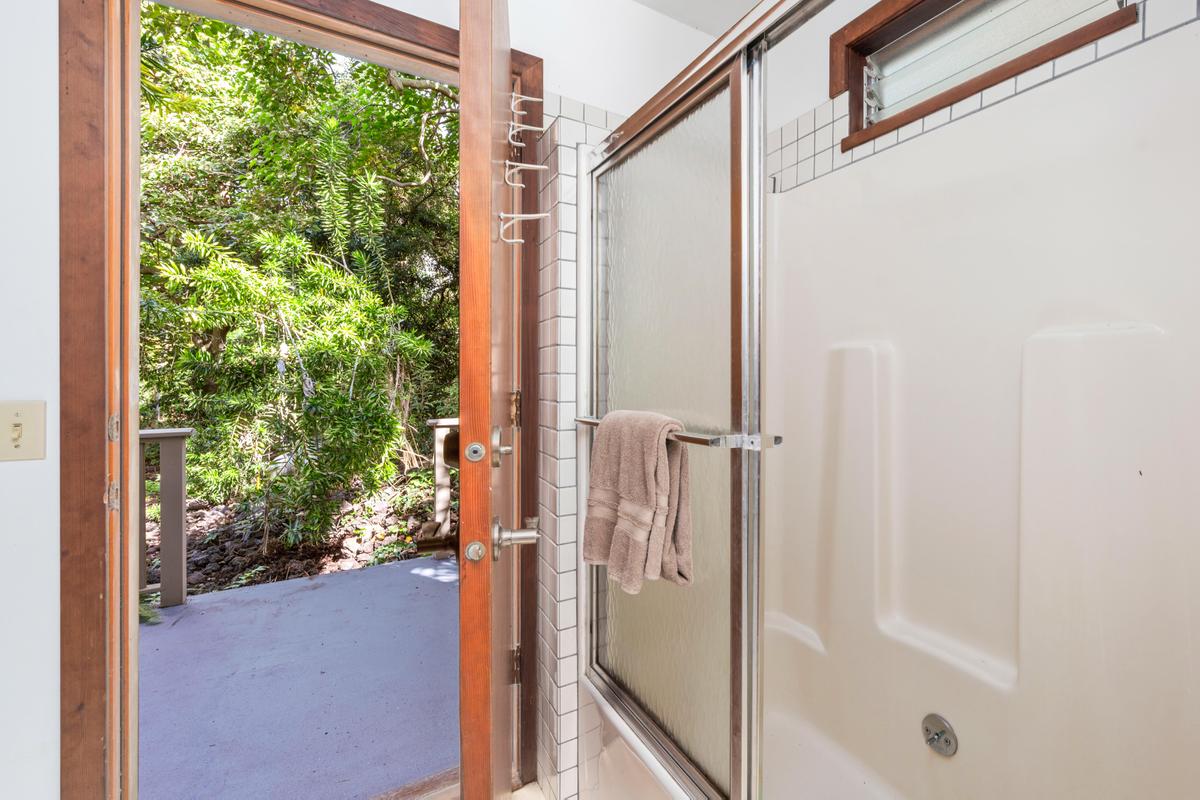 88-2497 Milolii Road Captain Cook, HI 96704 - Photo 17 of 30 a bathroom with a glass shower door