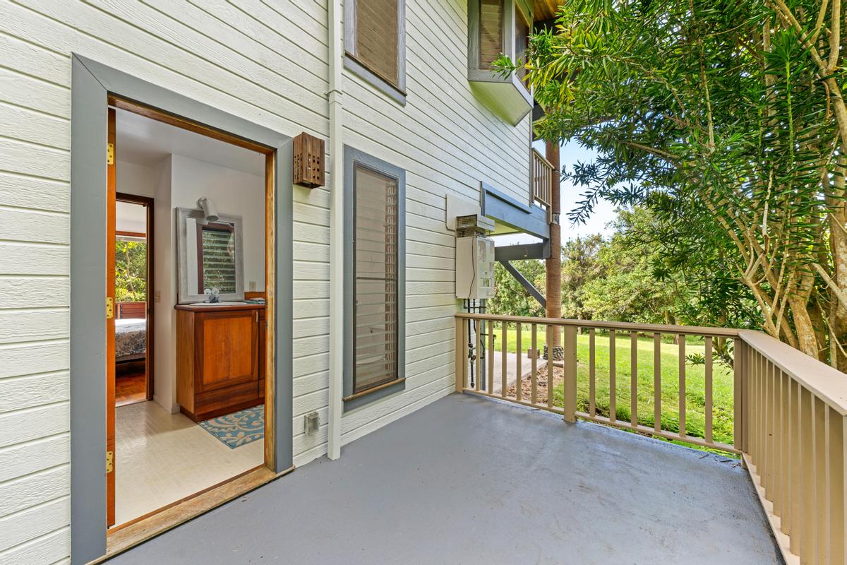 88-2497 Milolii Road Captain Cook, HI 96704 - Photo 18 of 30 a view of a porch with a door and wooden floor