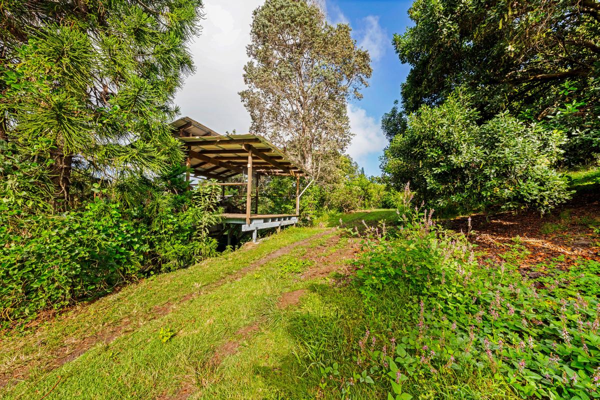 88-2497 Milolii Road Captain Cook, HI 96704 - Photo 22 of 30 a view of swimming pool with lawn chairs and plants