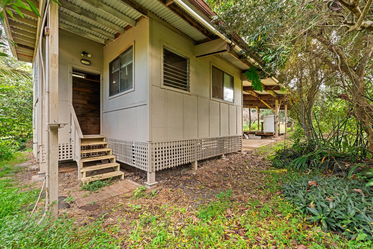 88-2497 Milolii Road Captain Cook, HI 96704 - Photo 25 of 30 a view of a house with a yard and wooden fence