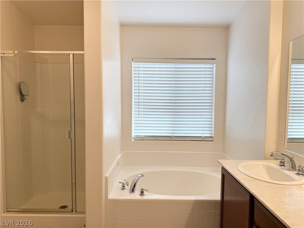 8231 Buffalo Ranch Avenue Las Vegas, NV 89147 - Photo 13 of 22 Relaxing soak in the garden tub or an invigorating shower, this primary bathroom provides both.