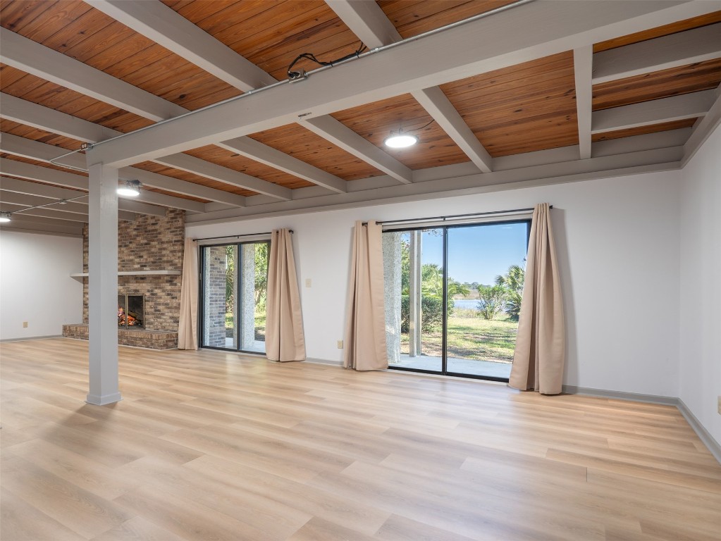 97578 Pirates Point Road Yulee, FL 32097 - Photo 14 of 64 an empty room with wooden floor and windows