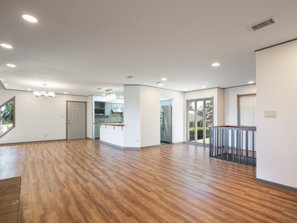 97578 Pirates Point Road Yulee, FL 32097 - Photo 18 of 64 a view of an empty room with wooden floor and windows
