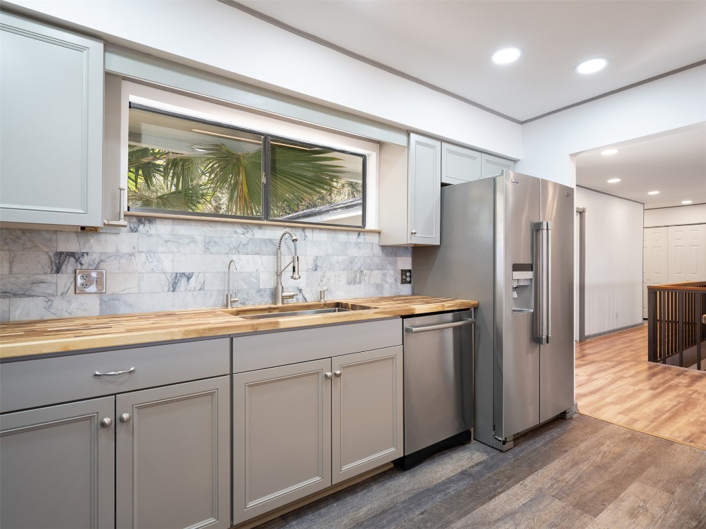 97578 Pirates Point Road Yulee, FL 32097 - Photo 22 of 64 a kitchen with stainless steel appliances granite countertop a refrigerator and a sink