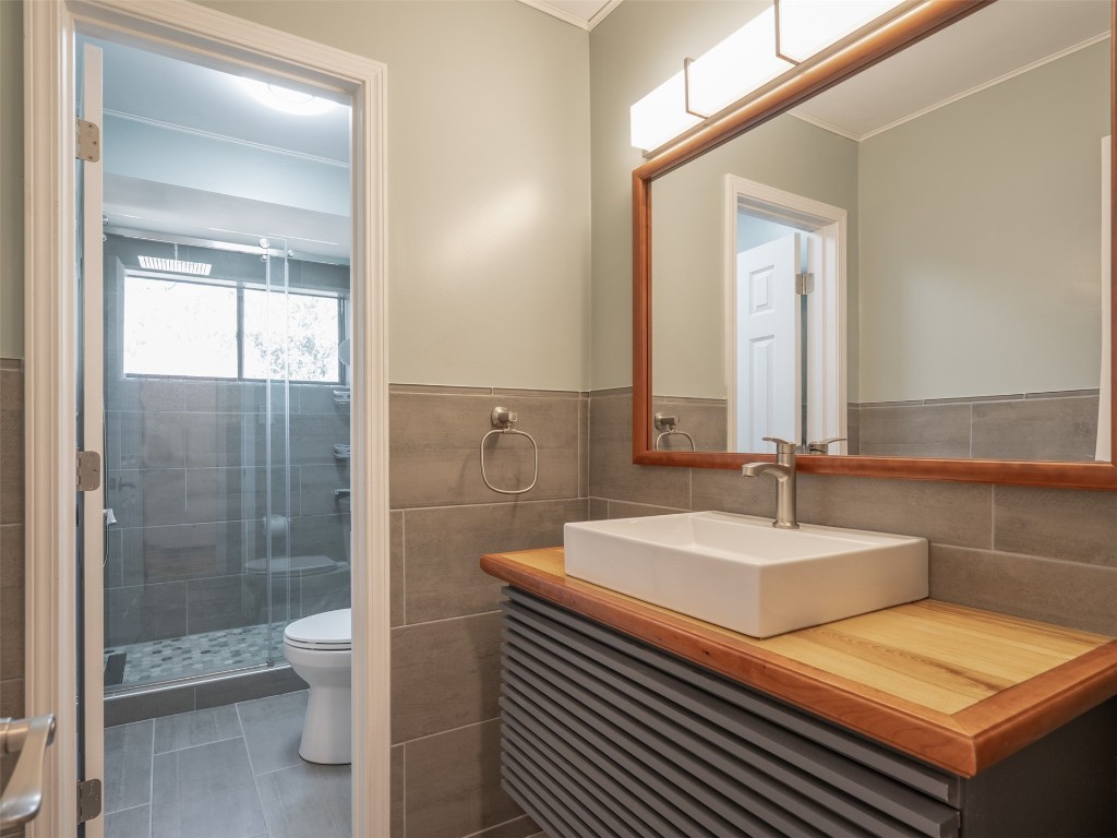 97578 Pirates Point Road Yulee, FL 32097 - Photo 29 of 64 a bathroom with a double vanity sink toilet and shower