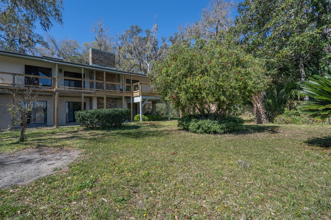 97578 Pirates Point Road Yulee, FL 32097 - Photo 47 of 64 a view of a house with a yard