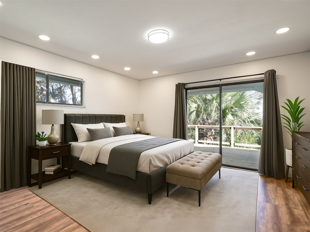 97578 Pirates Point Road Yulee, FL 32097 - Photo 6 of 64 a spacious bedroom with a bed and a large window