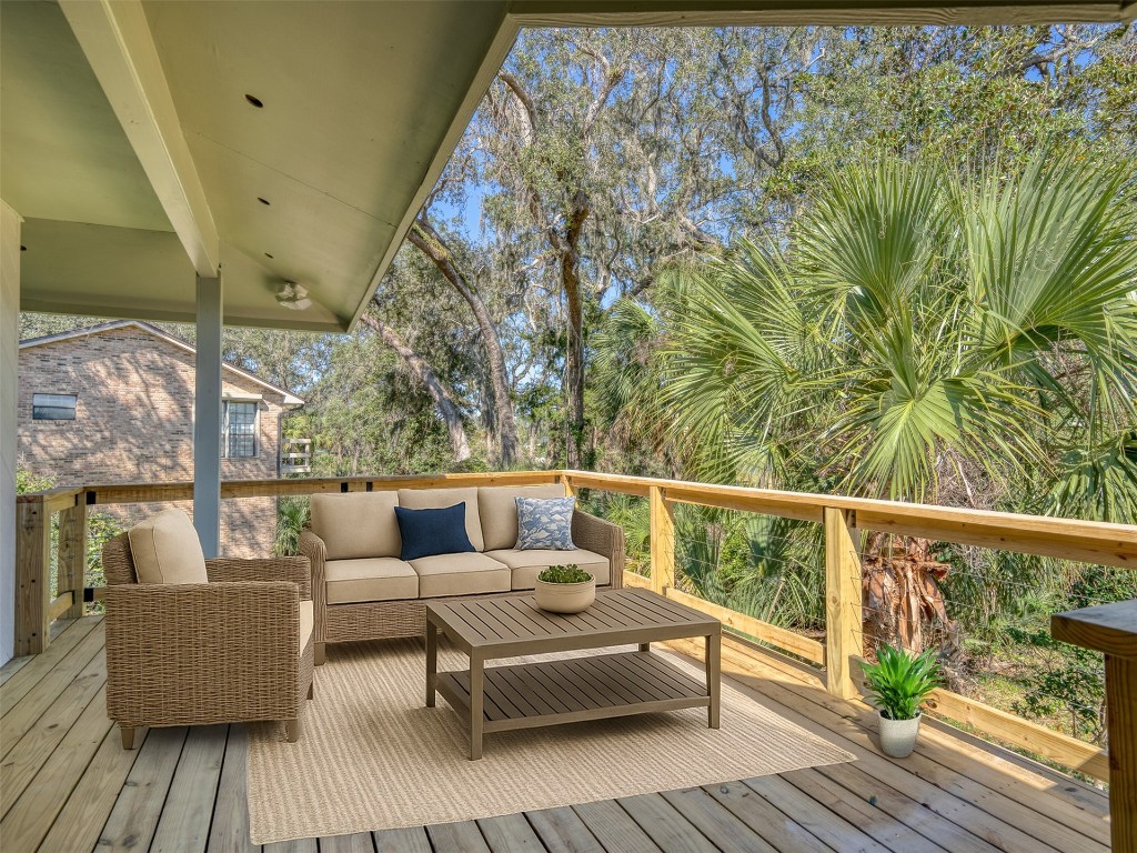 97578 Pirates Point Road Yulee, FL 32097 - Photo 7 of 64 a balcony with wooden floor and furniture