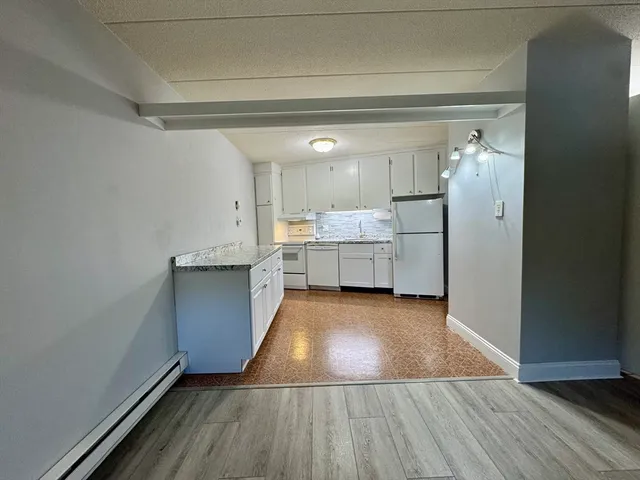 a view of kitchen and wooden floor