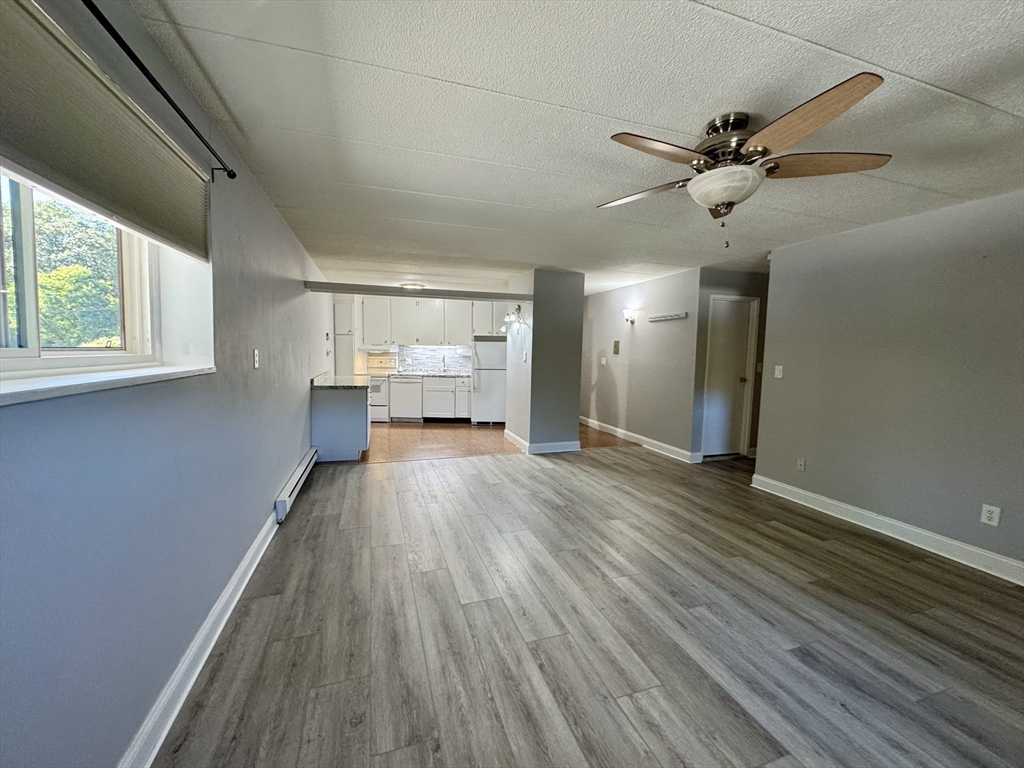 147 Turner Road, Unit 80 Holliston, MA 01746 - Photo 14 of 22 a view of empty room with wooden floor and fan