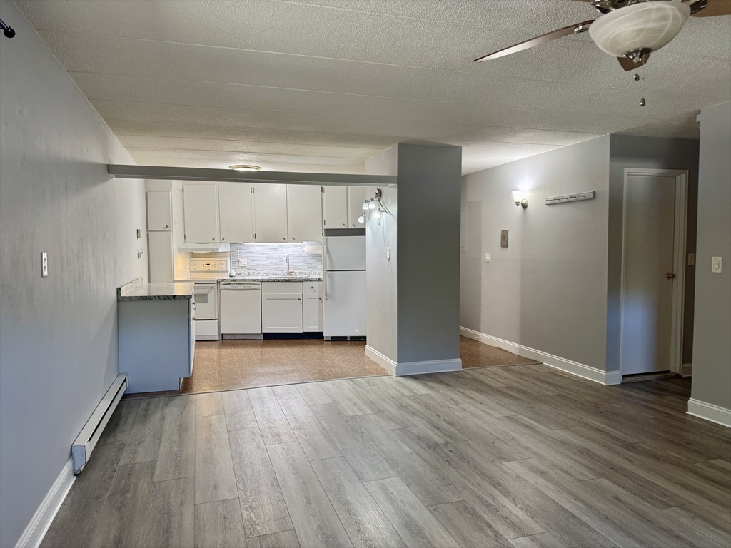 147 Turner Road, Unit 80 Holliston, MA 01746 - Photo 15 of 22 an empty room with wooden floor and windows