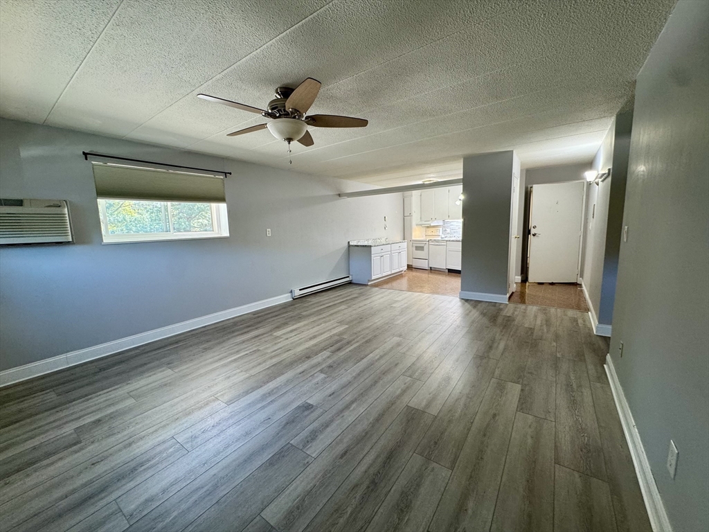 147 Turner Road, Unit 80 Holliston, MA 01746 - Photo 16 of 22 a view of a big room with wooden floor a ceiling fan and windows