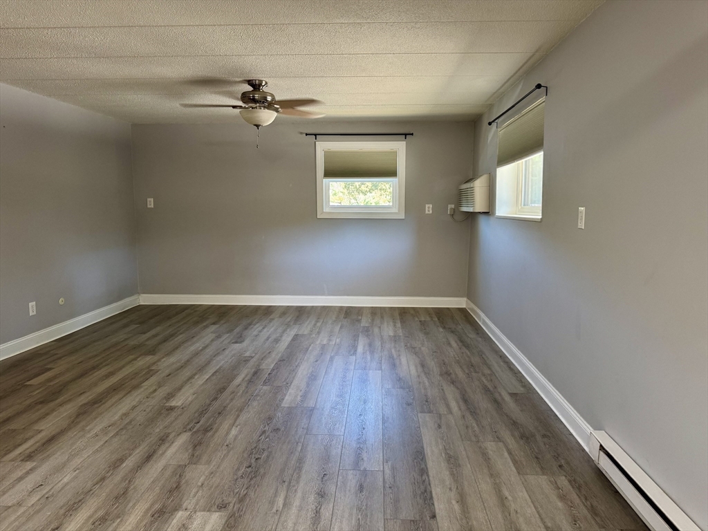 147 Turner Road, Unit 80 Holliston, MA 01746 - Photo 2 of 22 wooden floor in an empty room with a window
