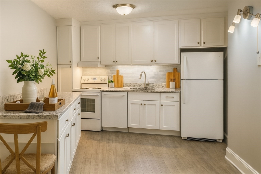 147 Turner Road, Unit 80 Holliston, MA 01746 - Photo 3 of 22 a kitchen with white cabinets and white appliances