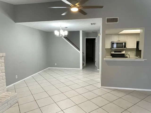 a view of a kitchen with microwave and cabinets