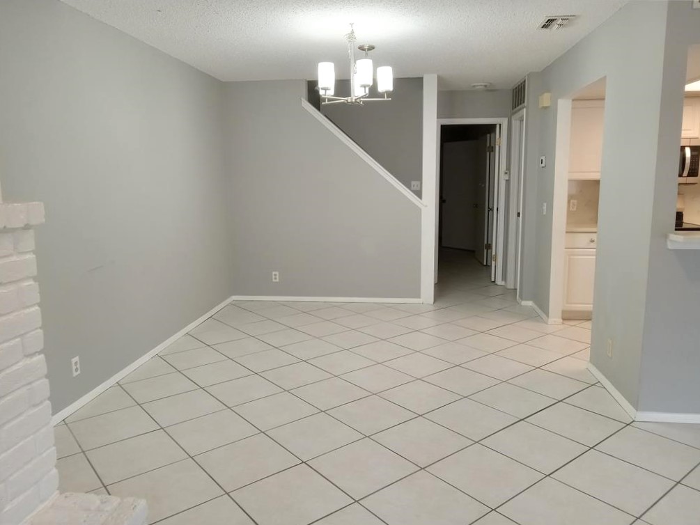 910 East Meadowmere Lane Austin, TX 78758 - Photo 4 of 27 a view of an empty room and chandelier fan
