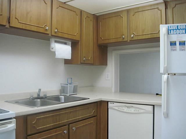 1900 South Kanner Highway, Unit 3104 Stuart, FL 34994 - Photo 9 of 20 a kitchen with granite countertop cabinets stainless steel appliances and sink