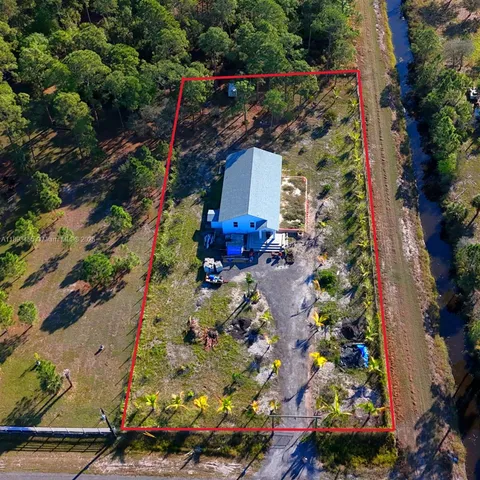 an aerial view of house with yard
