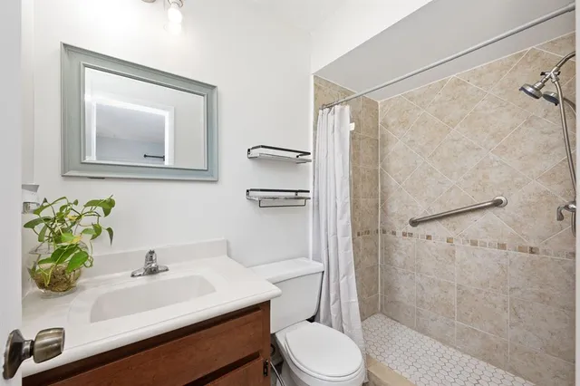 a bathroom with a sink toilet and shower
