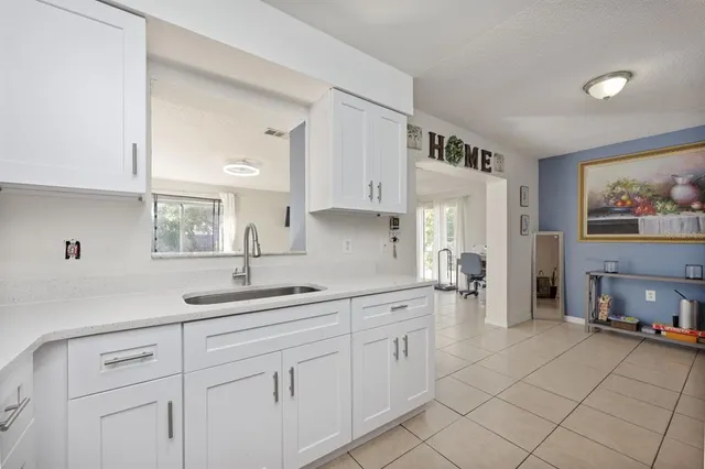a kitchen with cabinets and window