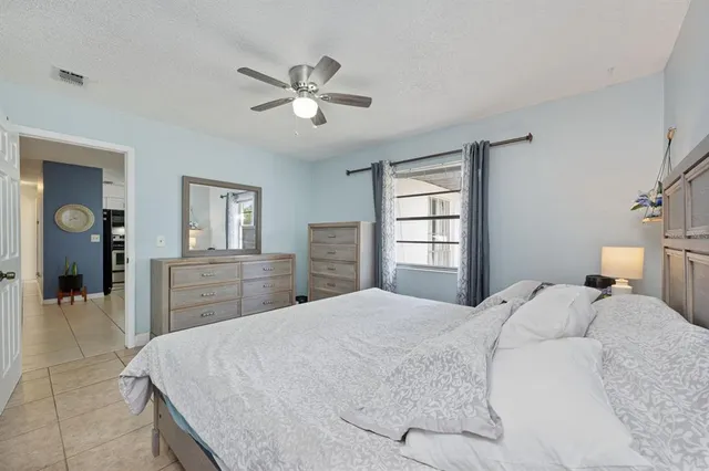 a bedroom with a large bed and a chandelier