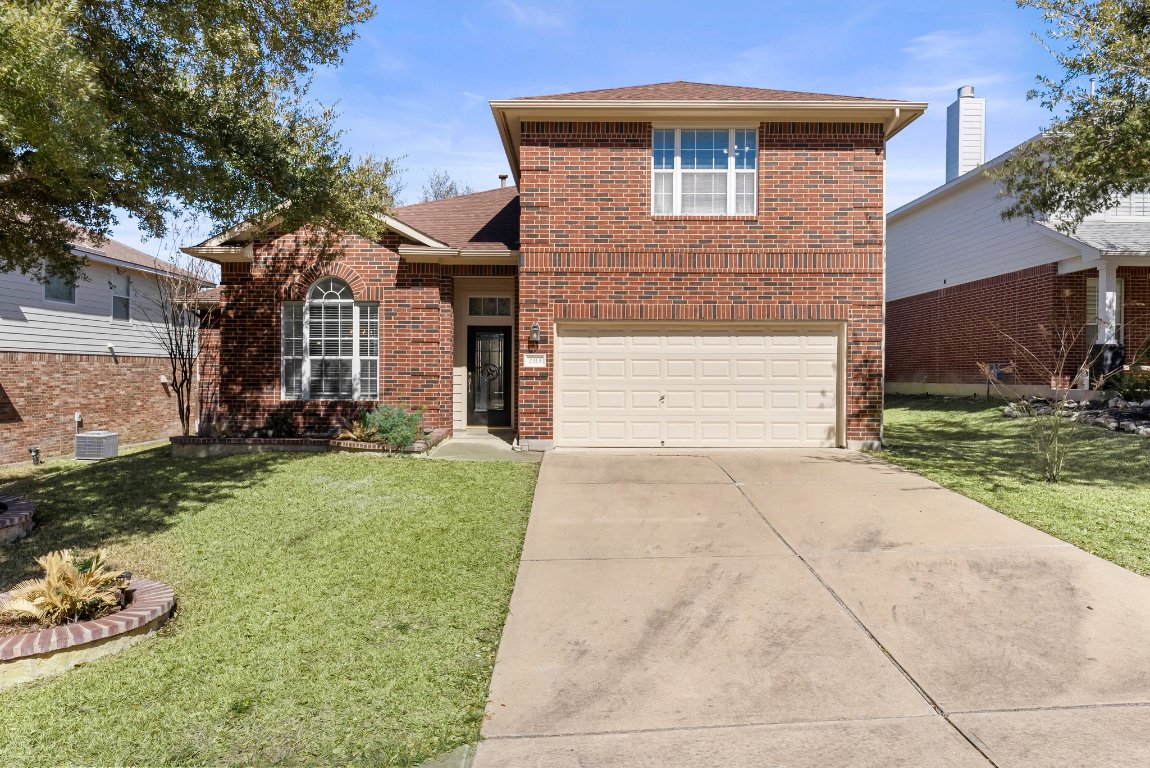 2313 Boulder Run Georgetown, TX 78626 - Photo 1 of 27 a front view of a house with a yard and garage