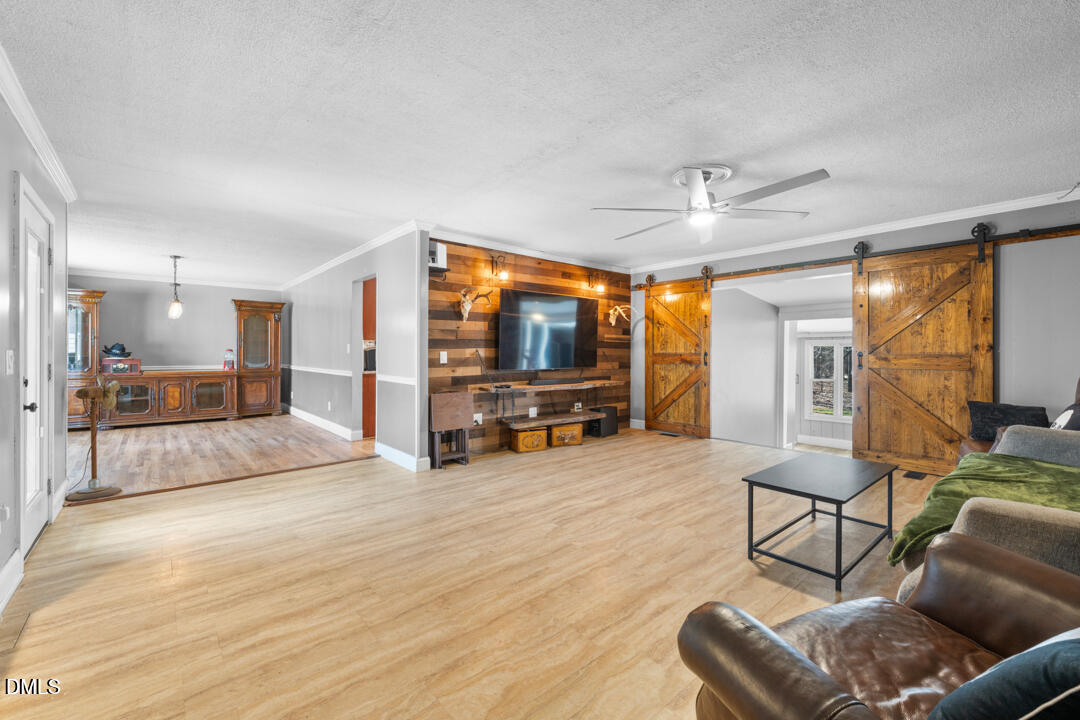 4739 Wild Azalea Place Rougemont, NC 27572 - Photo 6 of 48 a living room with furniture and a flat screen tv