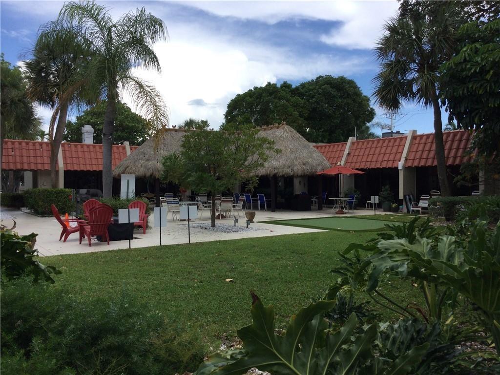 777 South Federal Highway, Unit 511RP Pompano Beach, FL 33062 - Photo 16 of 37 a front view of a house with a garden and trees