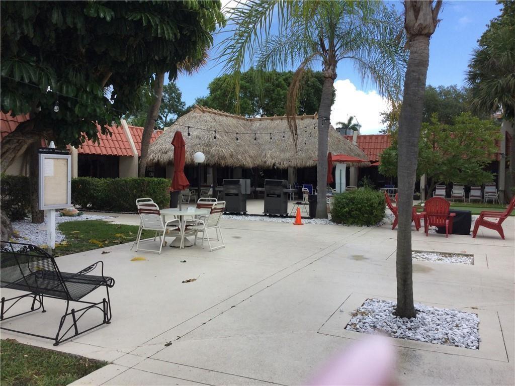 777 South Federal Highway, Unit 511RP Pompano Beach, FL 33062 - Photo 21 of 37 a view of the patio with dining table and chairs under an umbrella
