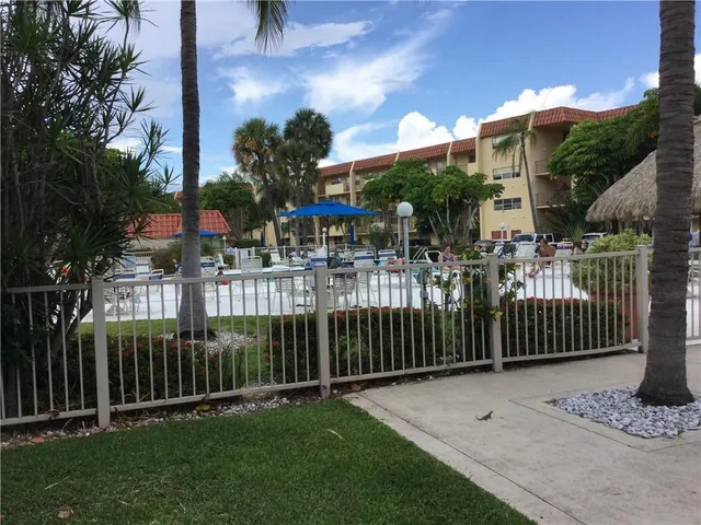 a wooden bench sitting in front of a building