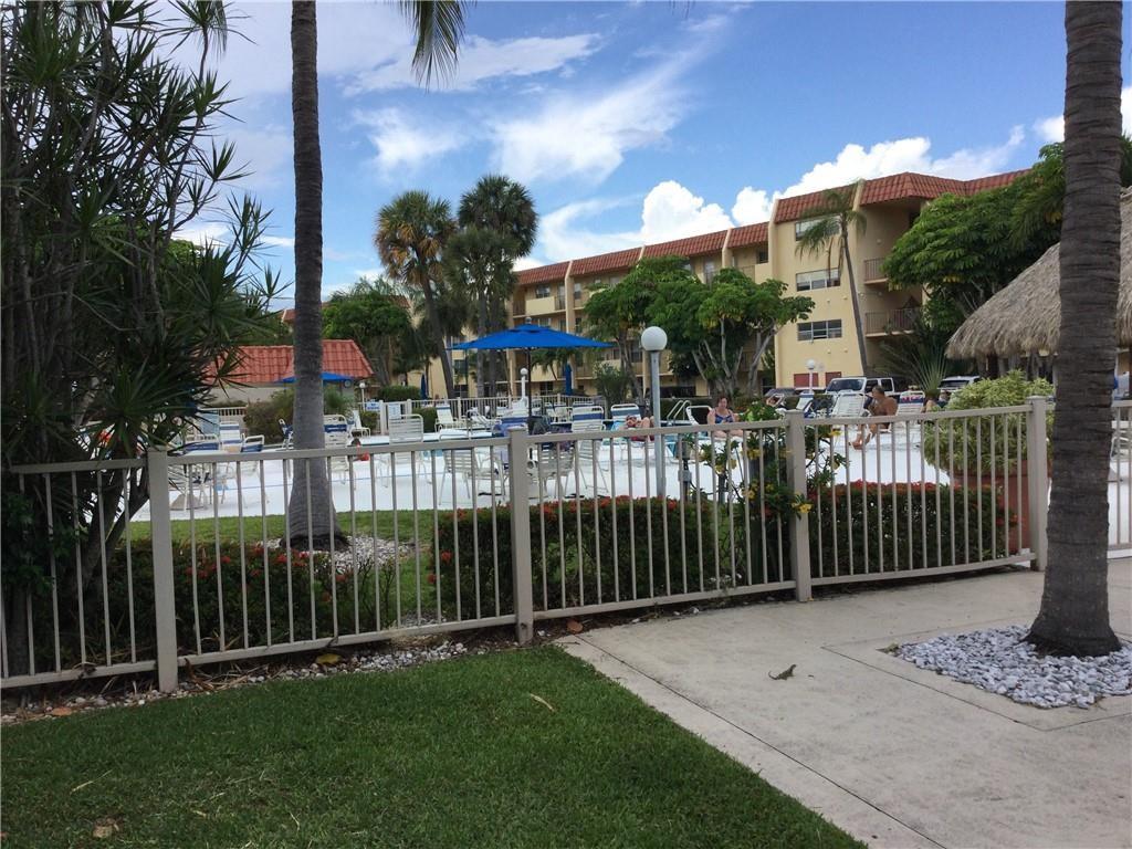777 South Federal Highway, Unit 511RP Pompano Beach, FL 33062 - Photo 22 of 37 a view of a brick house with a small yard and plants