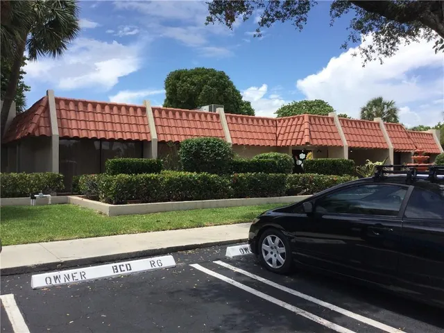 a view of a roof deck with couches and wooden floor