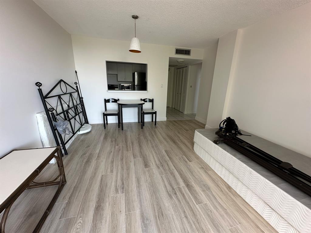 777 South Federal Highway, Unit 511RP Pompano Beach, FL 33062 - Photo 3 of 37 a living room with furniture and a wooden floor