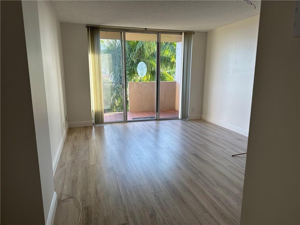 777 South Federal Highway, Unit 511RP Pompano Beach, FL 33062 - Photo 5 of 37 a view of an empty room with wooden floor and a window