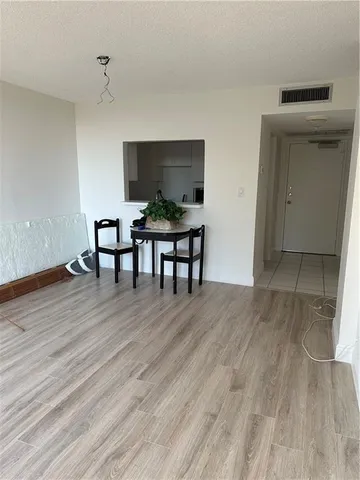 a view of a livingroom with furniture and wooden floor