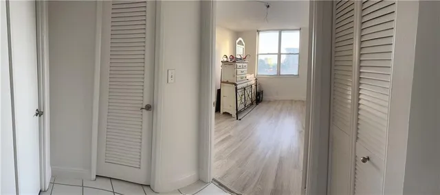 a view of entryway with wooden floor and cabinet