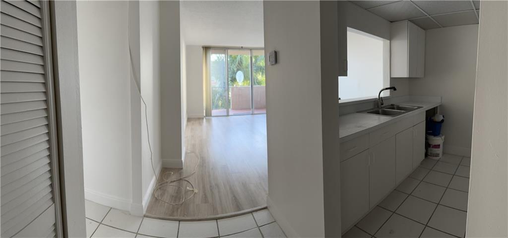 777 South Federal Highway, Unit 511RP Pompano Beach, FL 33062 - Photo 8 of 37 a kitchen with a sink and cabinets
