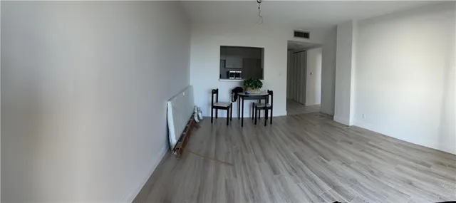 a dining room with furniture wooden floor and a rug
