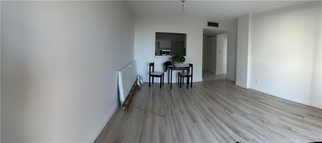777 South Federal Highway, Unit 511RP Pompano Beach, FL 33062 - Photo 9 of 37 a dining room with furniture wooden floor and a rug