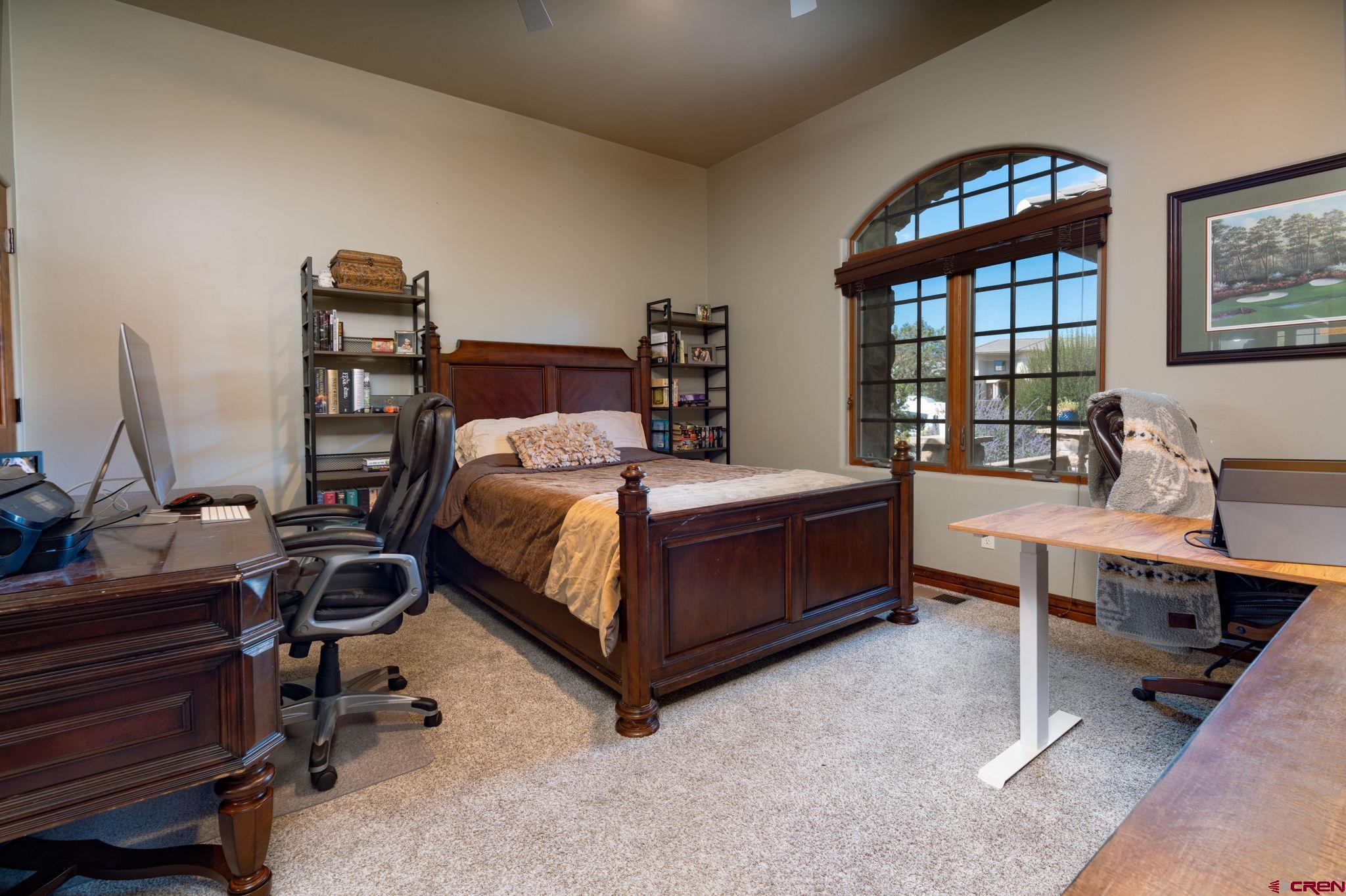 358 High Desert Road Grand Junction, CO 81507 - Photo 23 of 42 a bedroom with a bed and a desk