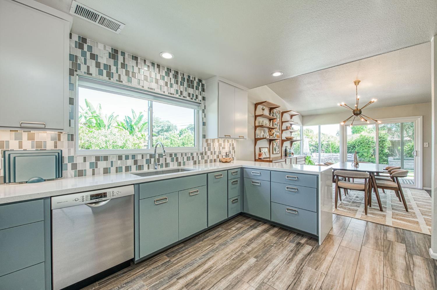 1527 West San Ramon Avenue Fresno, CA 93711 - Photo 15 of 55 a kitchen with sink cabinets and wooden floor
