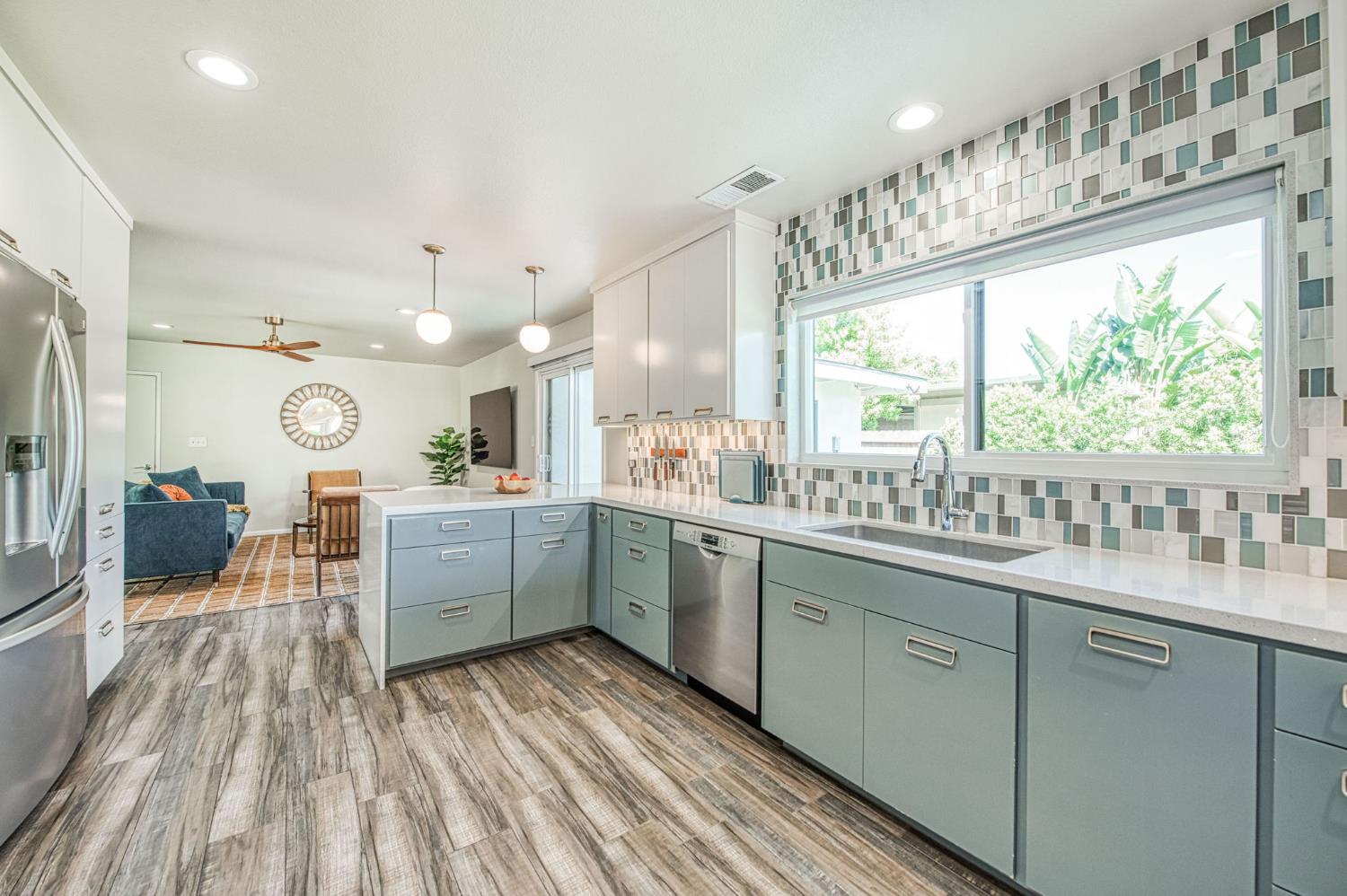 1527 West San Ramon Avenue Fresno, CA 93711 - Photo 16 of 55 a kitchen with cabinets a sink and appliances in it