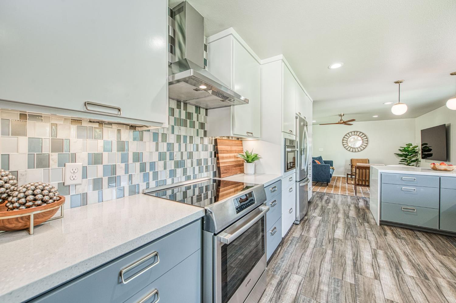 1527 West San Ramon Avenue Fresno, CA 93711 - Photo 17 of 55 a kitchen with stainless steel appliances granite countertop a sink and cabinets