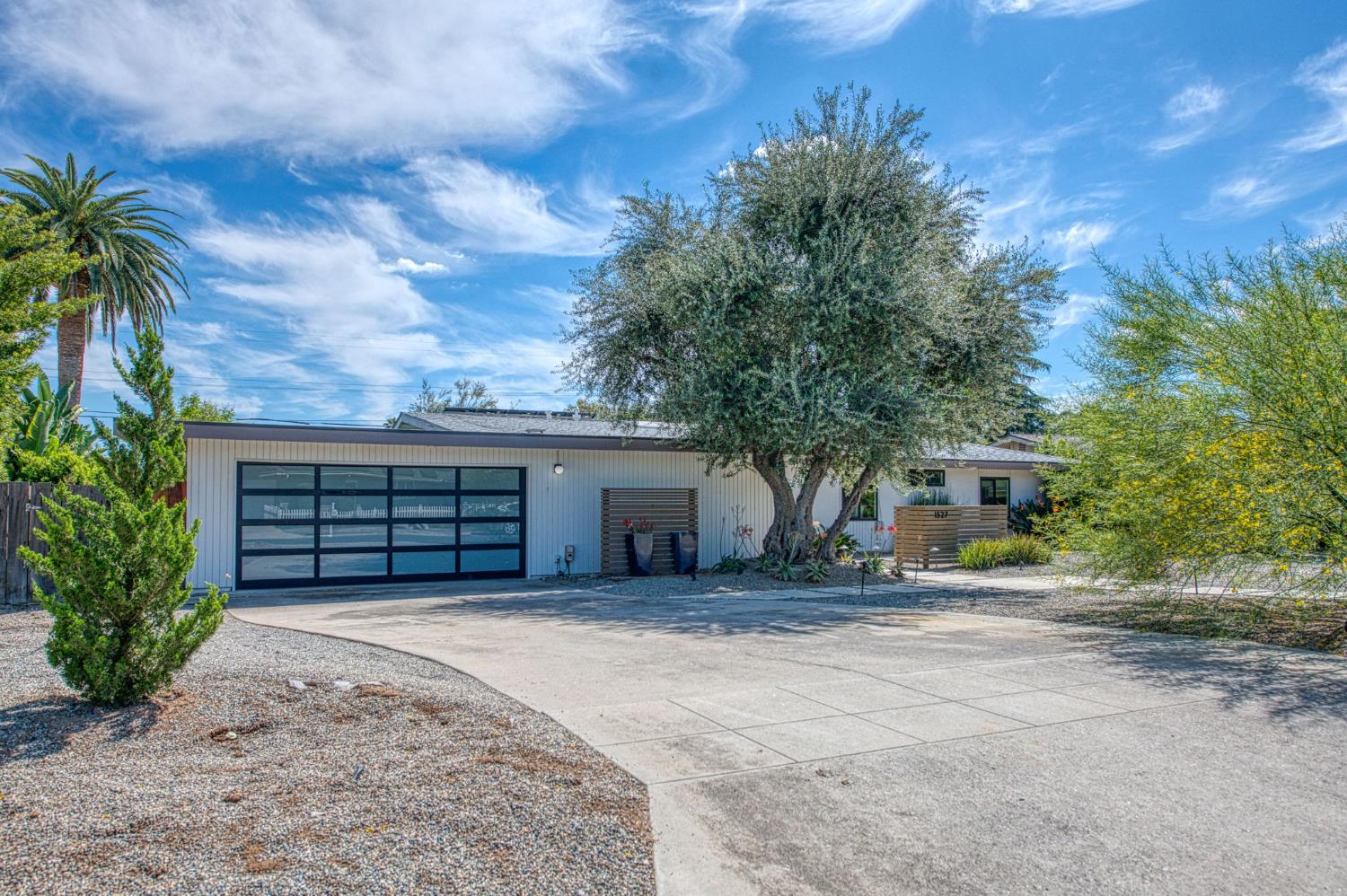 1527 West San Ramon Avenue Fresno, CA 93711 - Photo 2 of 55 front view of a house with a large yard and potted plants